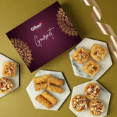 Gourmet pastries on marble plates with a 'Giftex' box on a green background